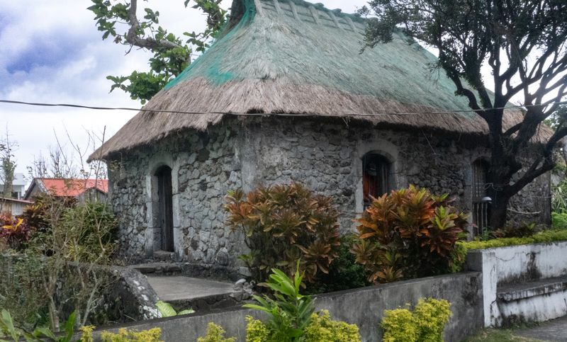 House of Dakay, the oldest Spanish colonial-era house in Ivana, from 1877. Note the person inside—the house still serves as a functional dwelling.