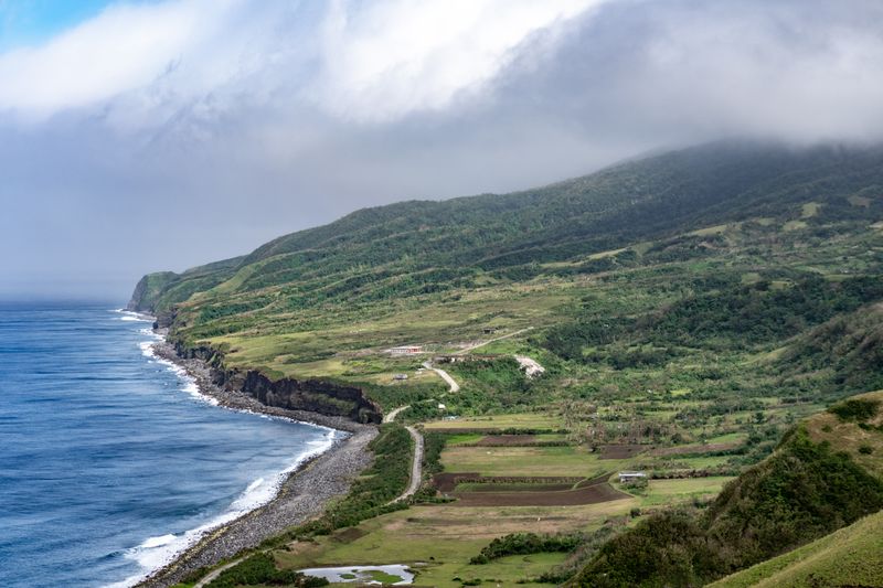 A view of Chapdipan beach, where its cliffs meet the sea—all the way from the Rolling Hills vantage point. Iraya is still hidden beneath the clouds. No cars, people in sight; quite surreal.