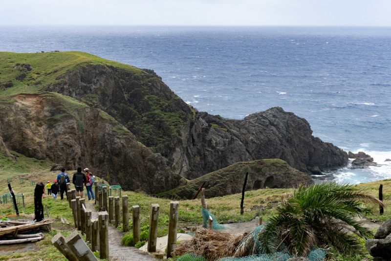 The apparently famous viewpoint outside Matel's. We opted to skip the short hike due to bad weather and the other incoming tourists, who can be seen in this photo. Note the lack of clear sedimentary strata in the rock—this is relatively younger igneous rock.