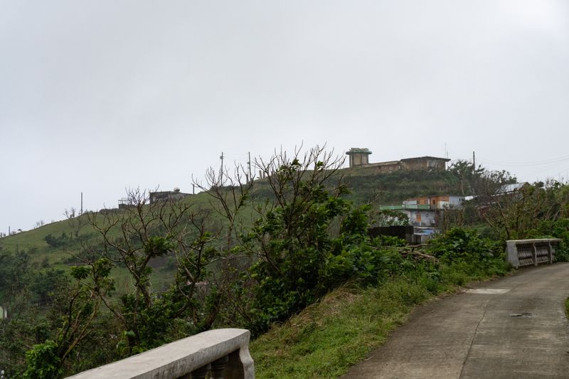 A defunct PAGASA weather station in the distance with a ruined tower. Gives Chernobyl vibes.